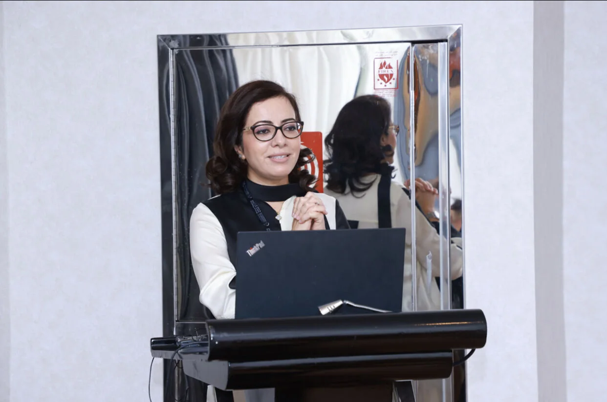 Dr Ghita Harifi speaking at a medical conference.